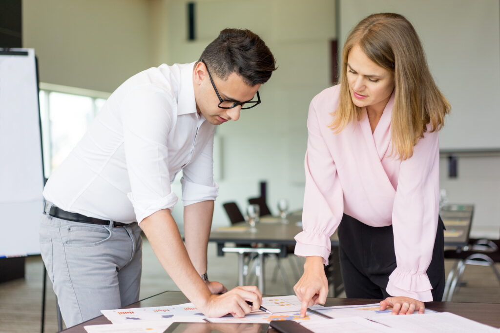 serious-male-female-colleagues-working-with-statistic-documents (1)